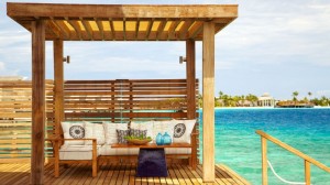 Wooden pergola Tribal pattern sofa cushions Wooden deck Maldives resort
